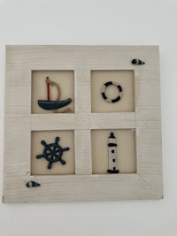 a wooden frame with various nautical items on it