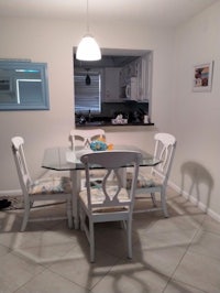 a kitchen with a table and chairs and a refrigerator