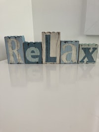 a set of wooden blocks with the word relax written on them